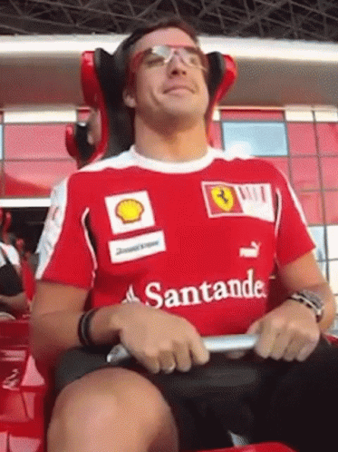 Man in Red Santander Shirt Sitting