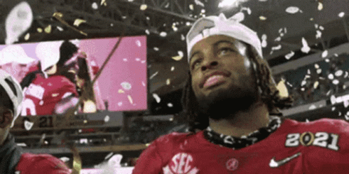 Man in Red SEC Jersey Standing in Front of Confetti