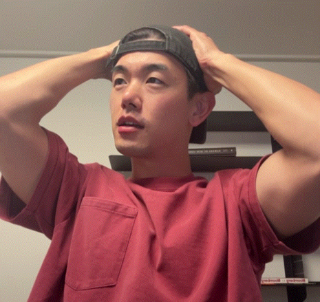 Man In Red Shirt And Black Hat Adjusting Hat GIF