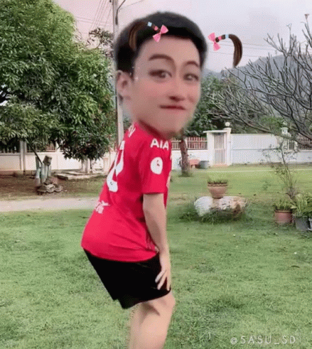 Man in Red Shirt and Black Shorts in Grass