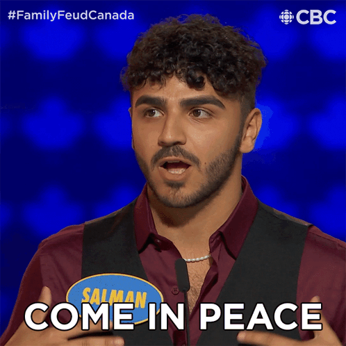 Man In Red Shirt And Black Vest Says Come In Peace GIF