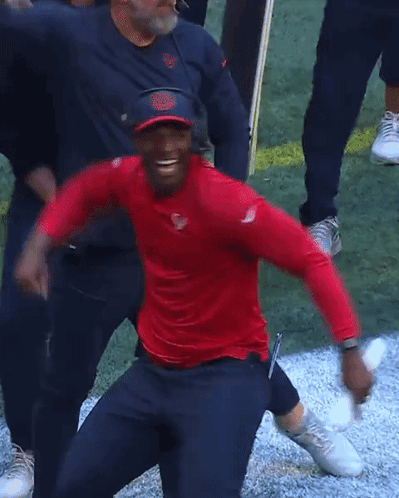 Man In Red Shirt And Blue Hat Next To Another Man GIF