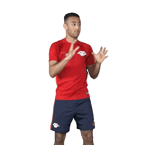 Man in Red Shirt and Blue Shorts Throwing Ball