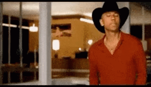 Man In Red Shirt And Cowboy Hat By Window GIF