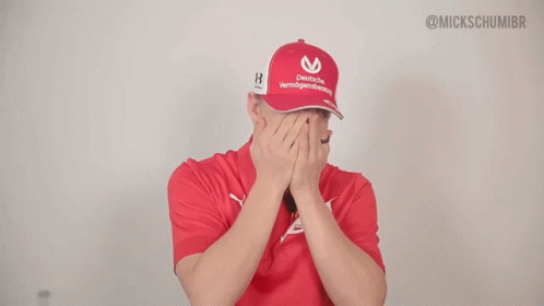 Man in Red Shirt and Hat Saying Emirates