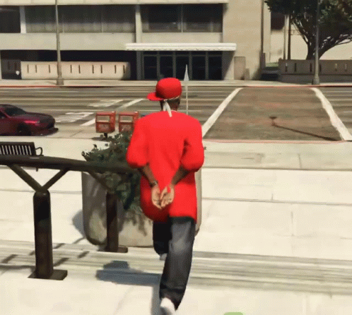 Man in Red Shirt and Hat Walking