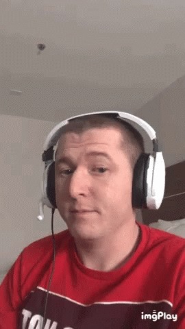 Man in Red Shirt and Headphones Saying Tow