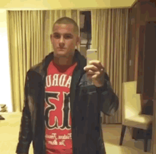 Man In Red Shirt And Leather Jacket Taking Selfie GIF