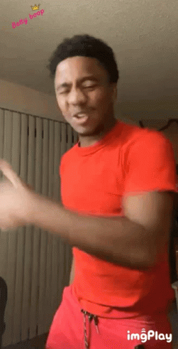 Man In Red Shirt And Red Shorts Dancing In Living Room GIF