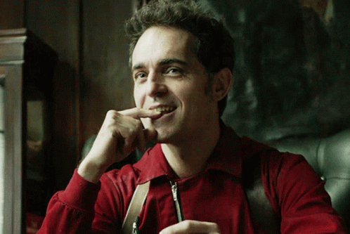 Man in Red Shirt and Suspenders Biting Nails