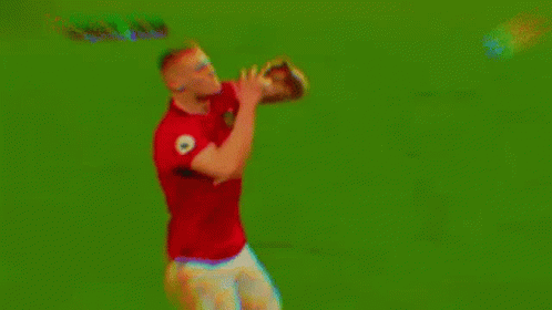 Man in Red Shirt and White Shorts Holding Soccer Ball