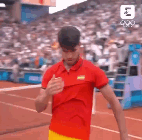 Man in Red Shirt and Yellow Shorts Running on Track