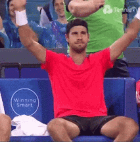 Man in Red Shirt Black Shorts Arms Up