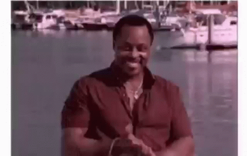 Man in Red Shirt Clapping at Marina