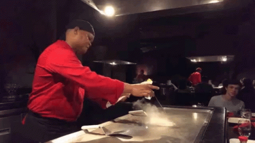 Man in Red Shirt Cooking on Stove