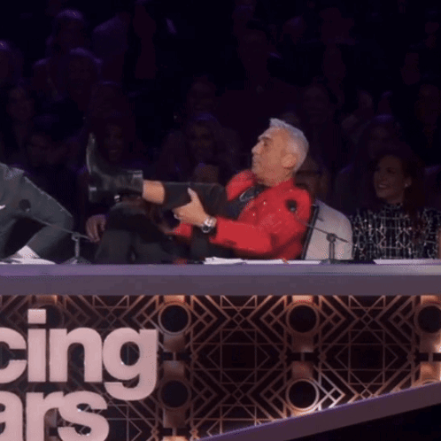 Man In Red Shirt Doing Split In Front Of Dancing With The Stars Sign GIF
