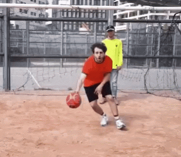 Man in Red Shirt Dribbling Basketball