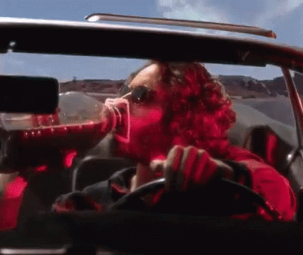 Man in Red Shirt Drinking While Driving