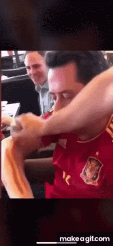 Man in Red Shirt Eating Hot Dog