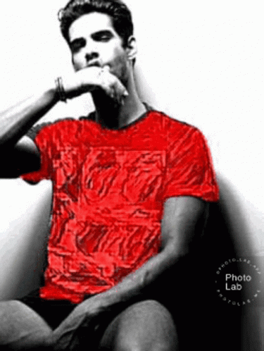 Man In Red Shirt Hand On Chin In Chair GIF