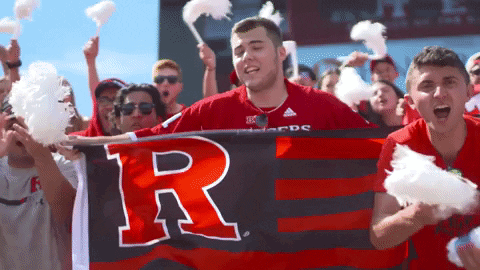 Man in Red Shirt Holding Banner Saying R