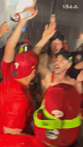 Man In Red Shirt Holding Bottle GIF