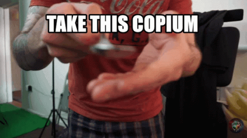 Man in Red Shirt Holding Coin Take This Copium