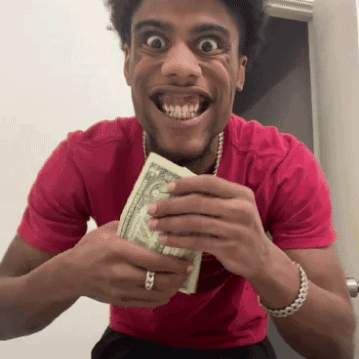 Man in Red Shirt Holding Dollar Bill in Mouth