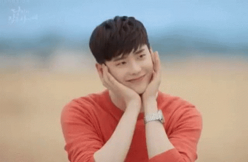 Man In Red Shirt Holding Face Smiling GIF