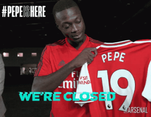 Man in Red Shirt Holding Pepe Jersey