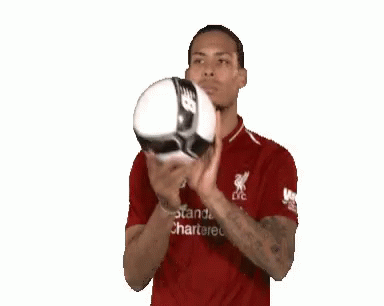 Man in Red Shirt Holding Soccer Ball