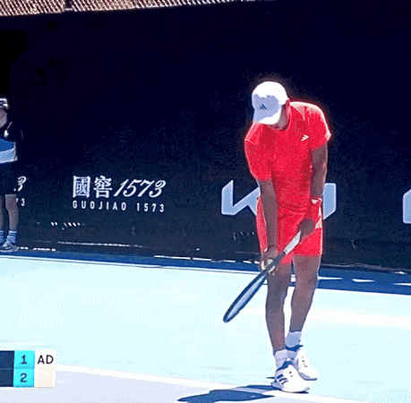 Man in Red Shirt Holding Tennis Racquet