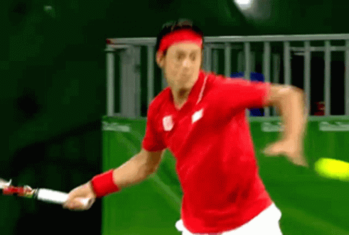 Man in Red Shirt Holding Tennis Racquet