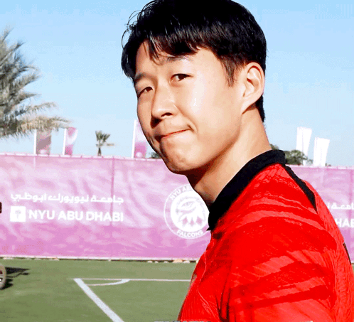 Man in Red Shirt in Front of NYU Abu Dhabi