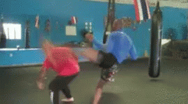 Man In Red Shirt Kicking Man In Blue Shirt GIF
