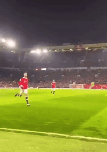 Man in Red Shirt Kicking Soccer Ball