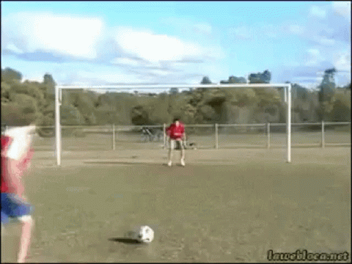 Man in Red Shirt Kicking Soccer Ball