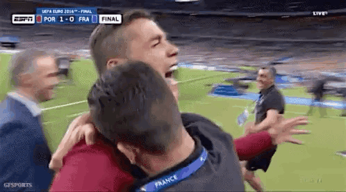 Man in Red Shirt Kicking Soccer Ball on Field