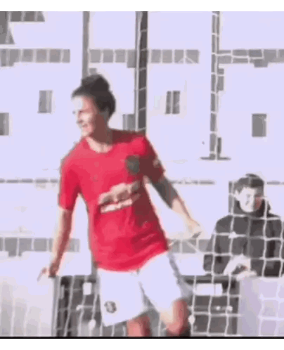 Man in Red Shirt Kicking Soccer Ball