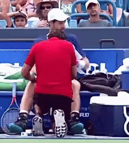 Man in Red Shirt Kneeling on Tennis Court