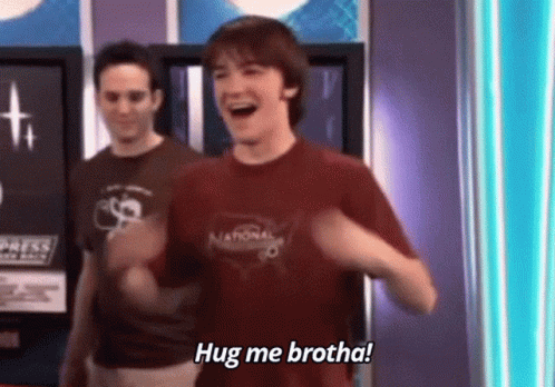 Man In Red Shirt Laughing Saying Hug Me Brotha Next To Another Man GIF