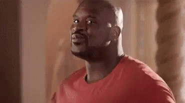 Man In Red Shirt Looking At Camera GIF