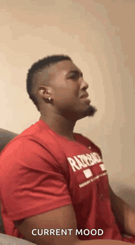 Man in Red Shirt Making Face