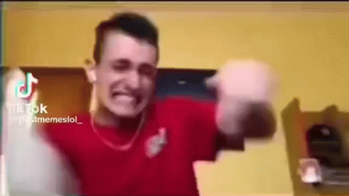 Man In Red Shirt Making Funny Face Holding Bottle GIF