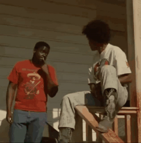 Man in Red Shirt Next to Man in White Shirt
