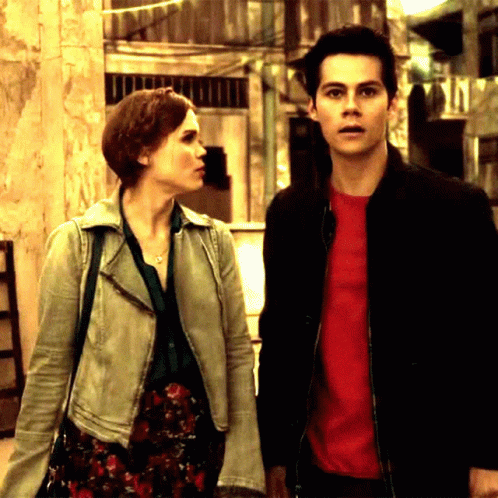 Man in Red Shirt Next to Woman in White Jacket