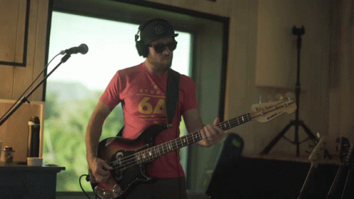 Man in Red Shirt No 64 Playing Bass Guitar