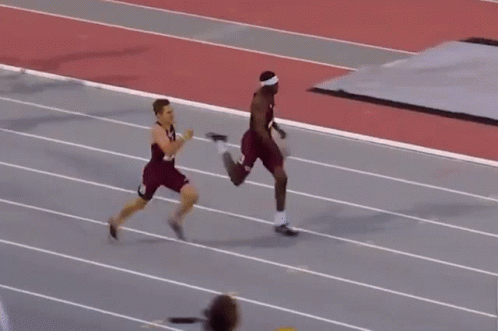 Man in Red Shirt Number 14 Falling on Track