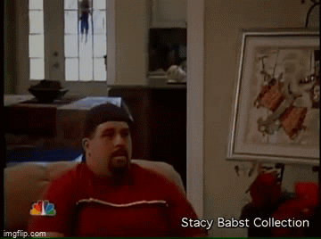 Man In Red Shirt On Couch Beside Stacy Babst Collection Framed Picture GIF