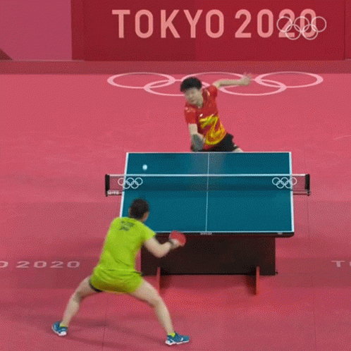 Man in Red Shirt Playing Ping Pong